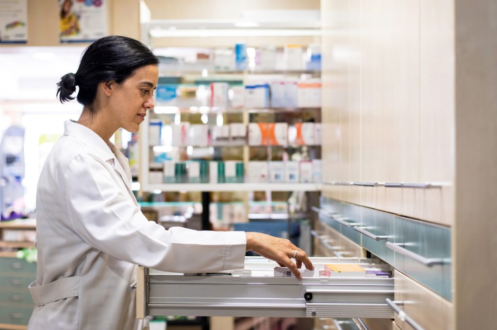 Pharmacist looking for prescription medication